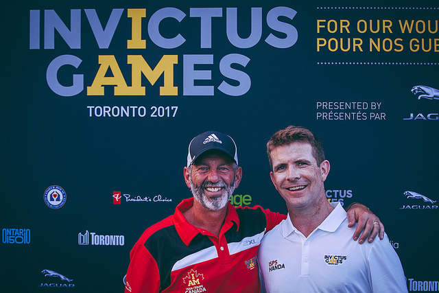 Dale Robillard (left) stands with another golfer.